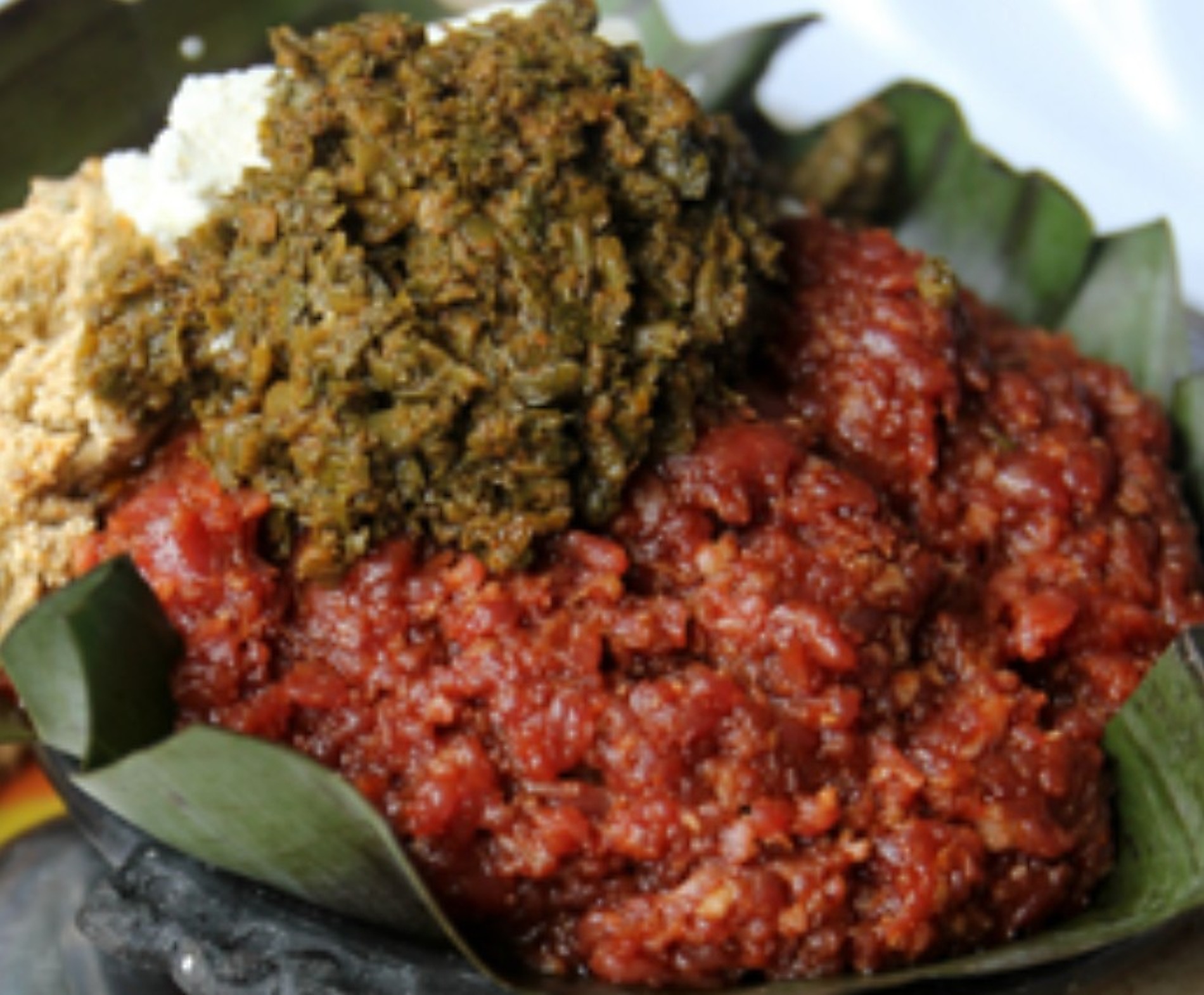 Traditional Ethiopian kitfo with greens and ayib